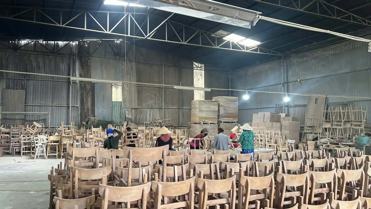 Workers at Aurora Craft factory producing wooden furniture as part of private label furniture manufacturing process