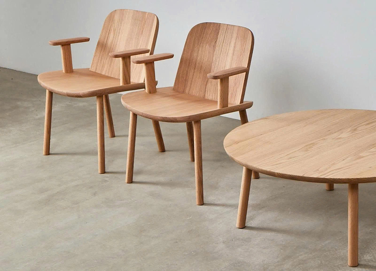Modern chair and round table set made from plywood, illustrating a versatile and cost-effective wood for outdoor furniture applications.