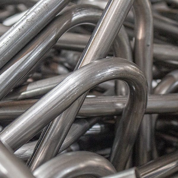 Raw metal tubing used in metal furniture production highlighting recyclability and material reuse