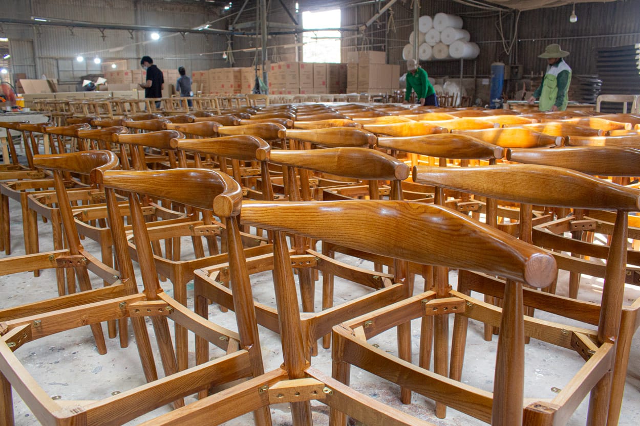 High-quality teak chairs in production at Aurora Craft, showcasing strategic material selection to optimize custom furniture costs