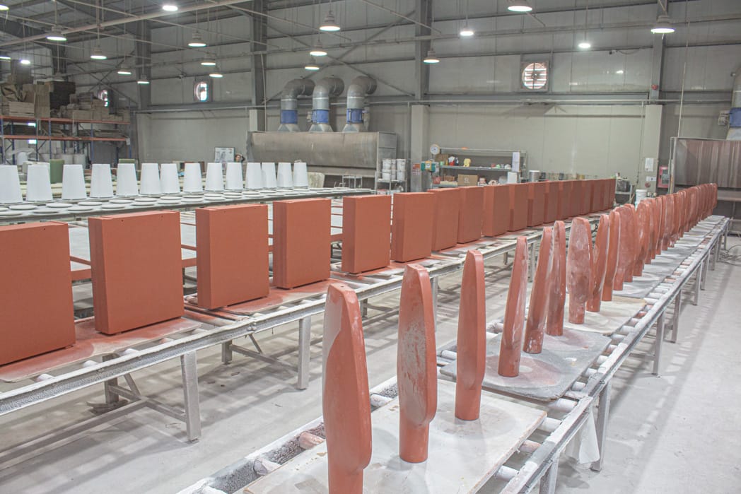 Furniture components with different finishes arranged in production batches during factory processing
