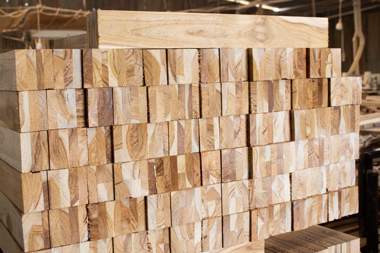 Wood raw materials prepared for production illustrating inventory costs that affect furniture manufacturing cost.